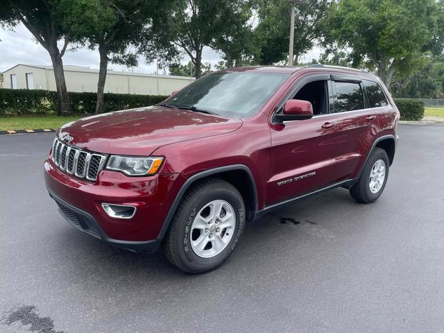 Burgundy Jeep Grand Cherokee with 125748 Miles available now!