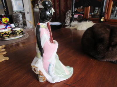 # 7 figurine of a women made in China hand painted 9.5