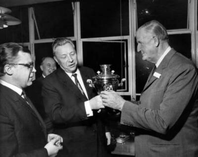 Visiting dignitary, Mr Burkov , Head of Novosti Agency, presents a- Old Photo