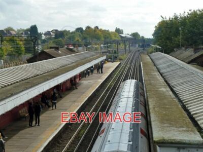 PHOTO  KENTON RAILWAY STATION A SOUTHBOUND BAKERLOO TRAIN IS DEPARTING. 2012