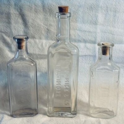 Old McCormick & Co. Extract Cork Bottle Plus Two Medicine Bottles Clear/Lavender
