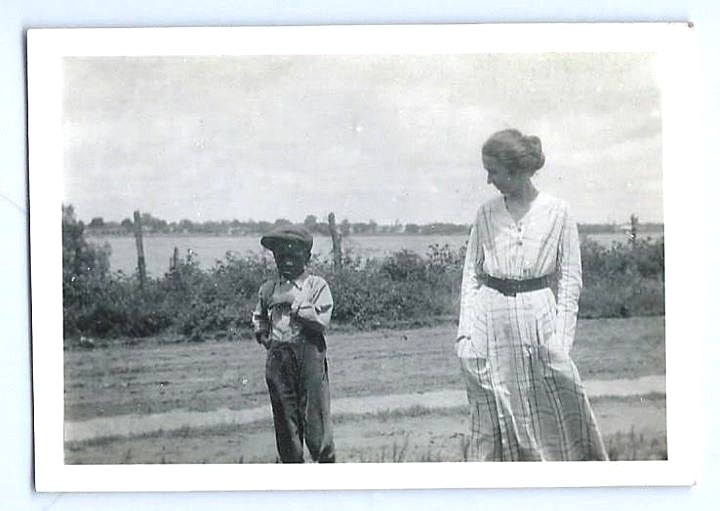 Pair of 1910's snapshot photographs of a white woman & African American boy