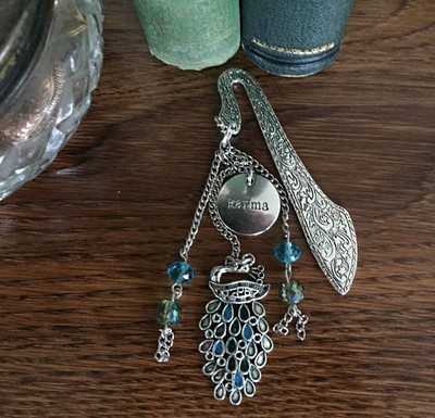 Karma is a Peacock on Ornate Silver Finish Bookmark with Blue & Green Swarovski