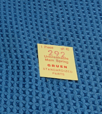 Gruen 292 mainspring PART # 615A (6 X 15 X 7.5) NEW OLD STOCK. (610E-712K)