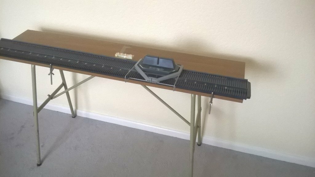 Bond Classic knitting machine with table, ribber, many accessories and