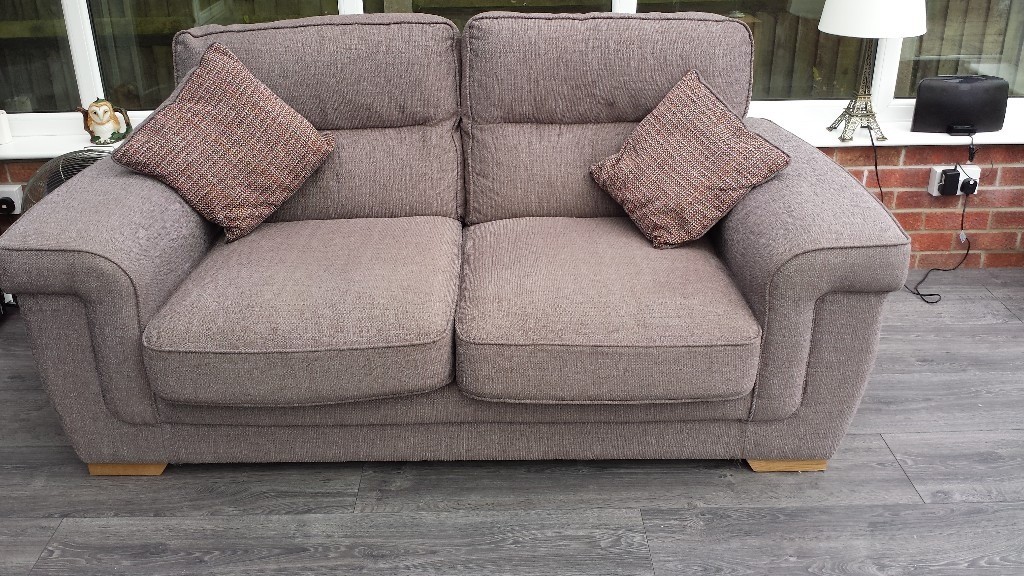 Pair of matching sofas with foot stool in CaisteronSea, Norfolk