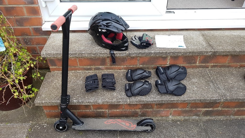 No Fear stunt scooter, helmet, gloves, and protective gear in