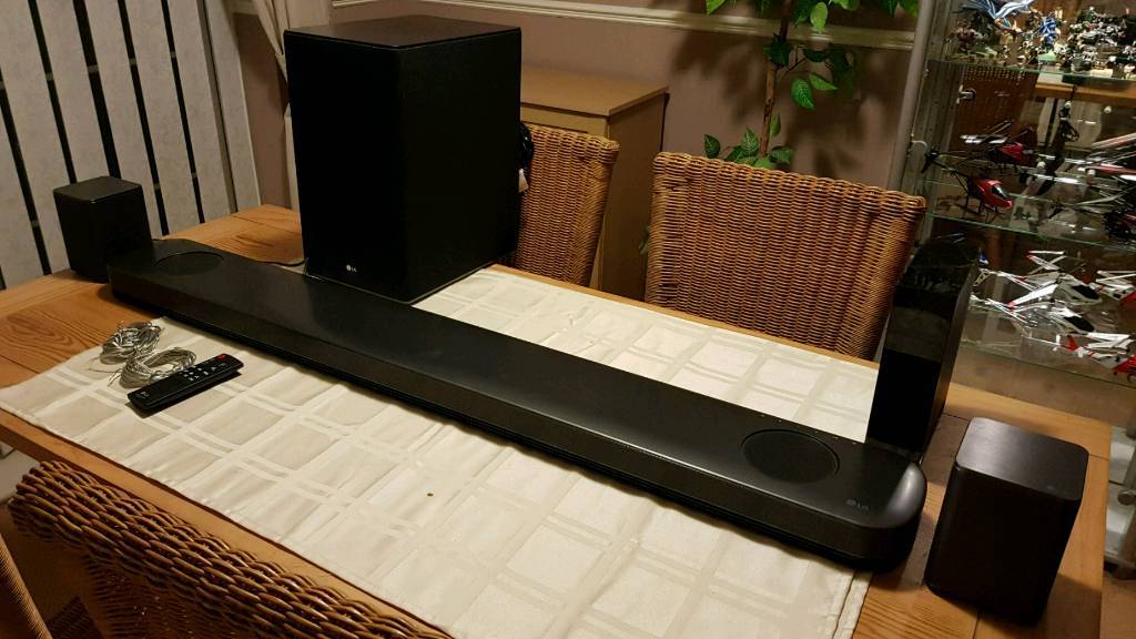 LG SK9Y Dolby Atmos Soundbar with 2 LG wireless rear surround speakers