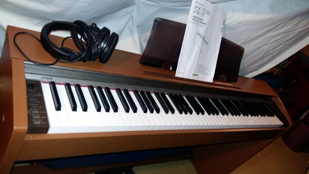 Pre-owned Casio electric/digital piano with headphones (PX 730) in good