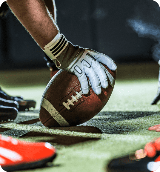 Hand holding football