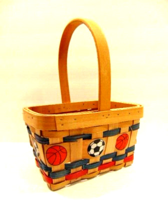 small woven wood basket with painted sports balls - football, soccer, etc