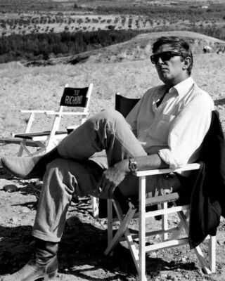 Robert Mitchum relaxes on 1968 Villa Rides set wearing sunglasses 11x17 poster