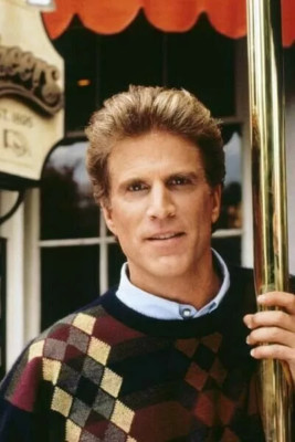 Ted Danson as Sam Malone stands at Cheers bar entrance