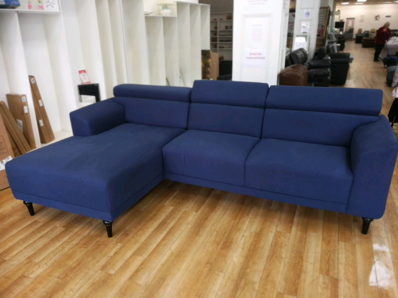 Blue fabric corner sofa with chaise and adjustable headrests in