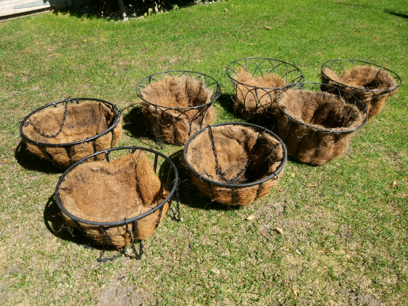 Metal hanging baskets lined with hessian sacking in Winchester