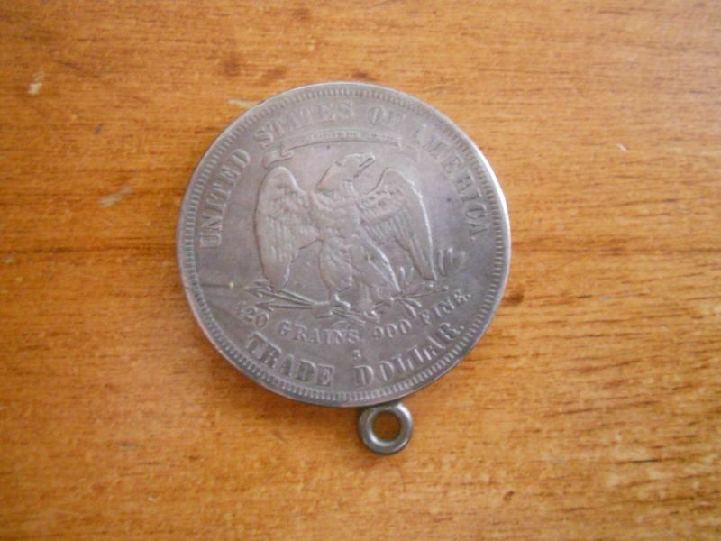 1877 seated Liberty Silver trade dollar coin ungraded with attached loop