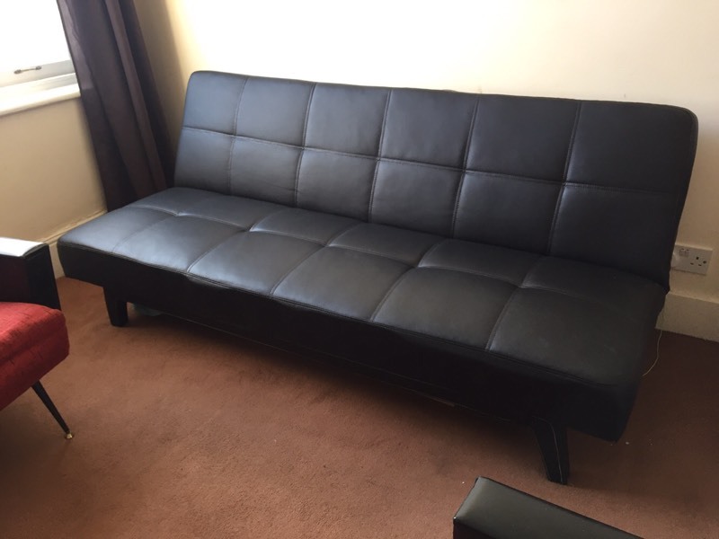 Lovely looking black faux leather 'clickclack' sofa bed / guest bed