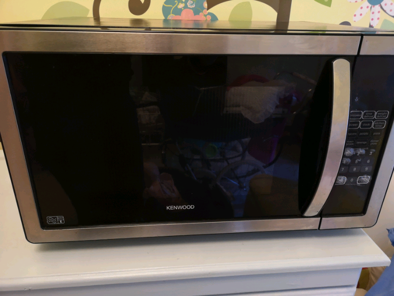 narrow cabinet next to refrigerator