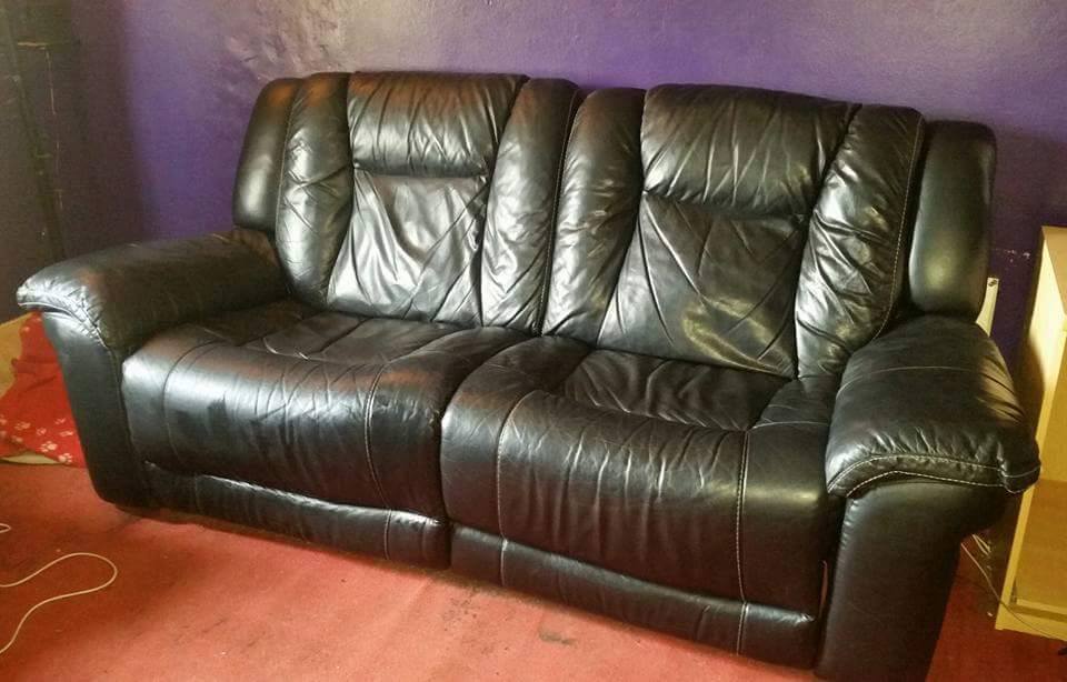 Large black leather DFS two seater sofa with manual reclining and