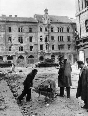 Woman picking some things amid ruins Hungarian capital front armed- Old Photo