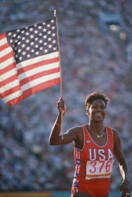 American track athlete Benita Fitzgerald-Brown holds up the Unite - Old Photo