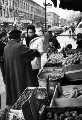 Italian American family picking some goods from greengrocer's stal- Old Photo