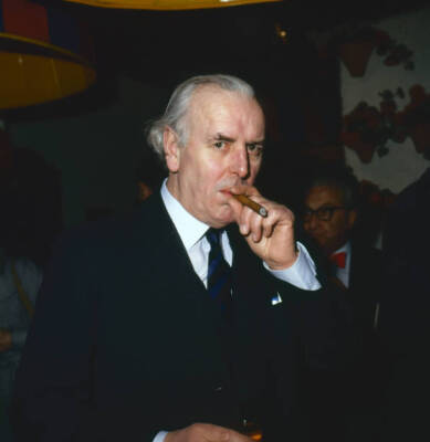 English actor George Cole as he smokes a cigar at an unspecified e- Old Photo