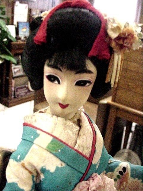2 CLOTH GEISHA DOLLS WITH SILK KIMONOS ON WOODEN STAND, ONE BLUE ONE PALE YELLOW