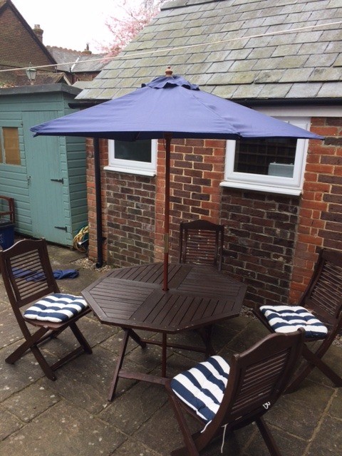 Firman teak garden table and four folding chairs | in Petersfield