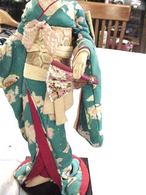 2 CLOTH GEISHA DOLLS WITH SILK KIMONOS ON WOODEN STAND, ONE BLUE ONE PALE YELLOW