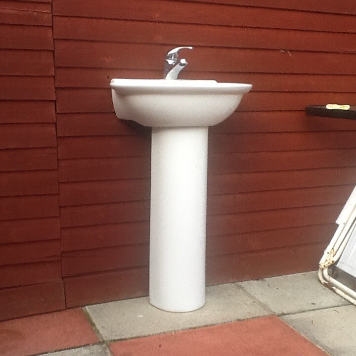 Small cloakroom sink with chrome taps with pedestal and a small