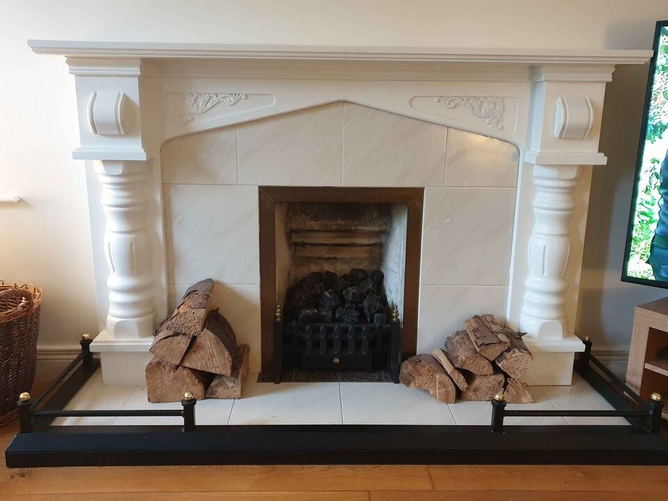 Painted wooden fire surround with tiled insert and hearth. in