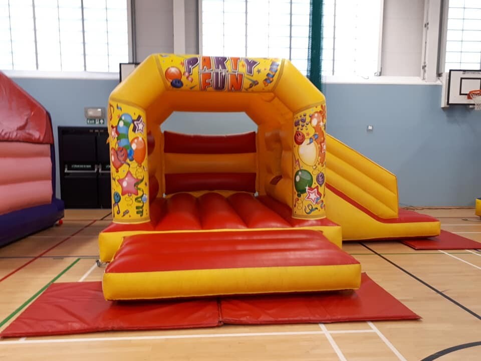 RED AND YELLOW BOUNCY CASTLE WITH SLIDE 18FT BY 15 FT FOR SALE in