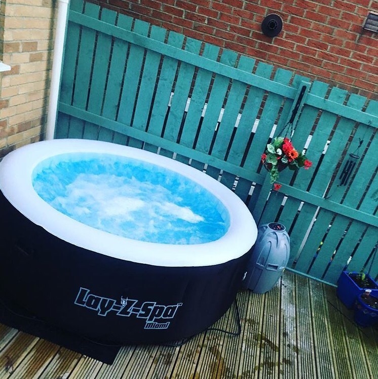 LayZ Spa Miami Hot Tub with cleaning chemicals and rubber mat in
