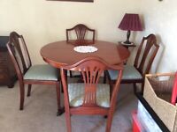 Round extending table and chairs and sideboard