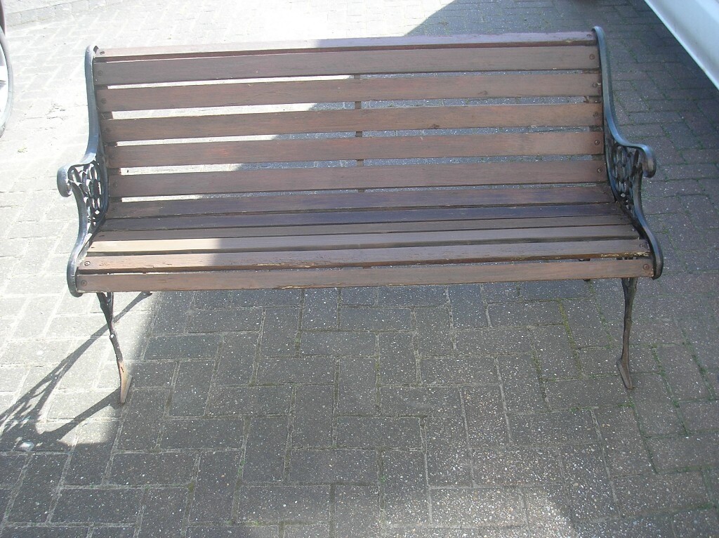 old garden bench with lions head on the cast iron legs 