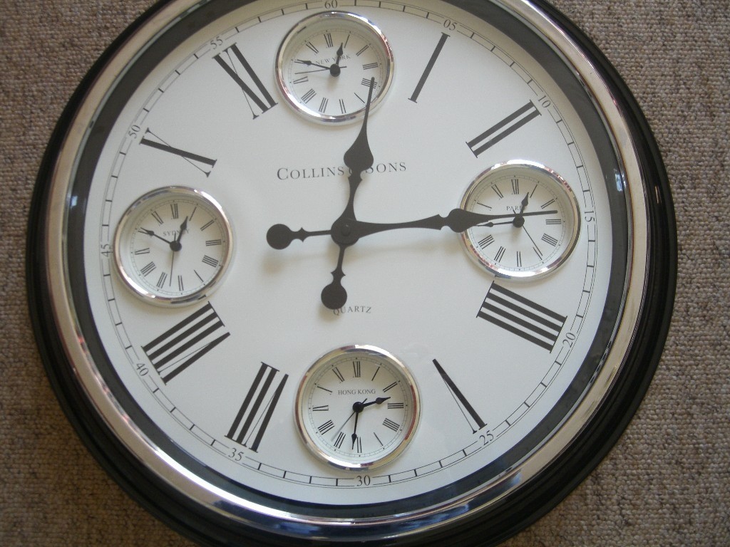 A Marks and Spencer large metal 4 time zone wall clock in Bodmin