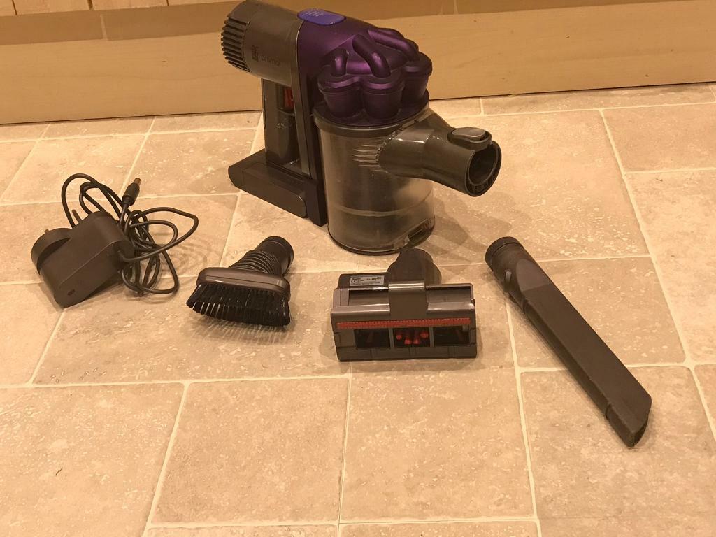 Dyson Animal DC31 handheld vacuum with 3 accessories and charger in