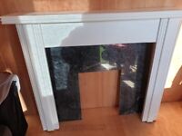 Wooden surround and black marble hearth 