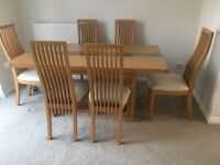 Dining table wood veneer and 6 faux leather chairs. 