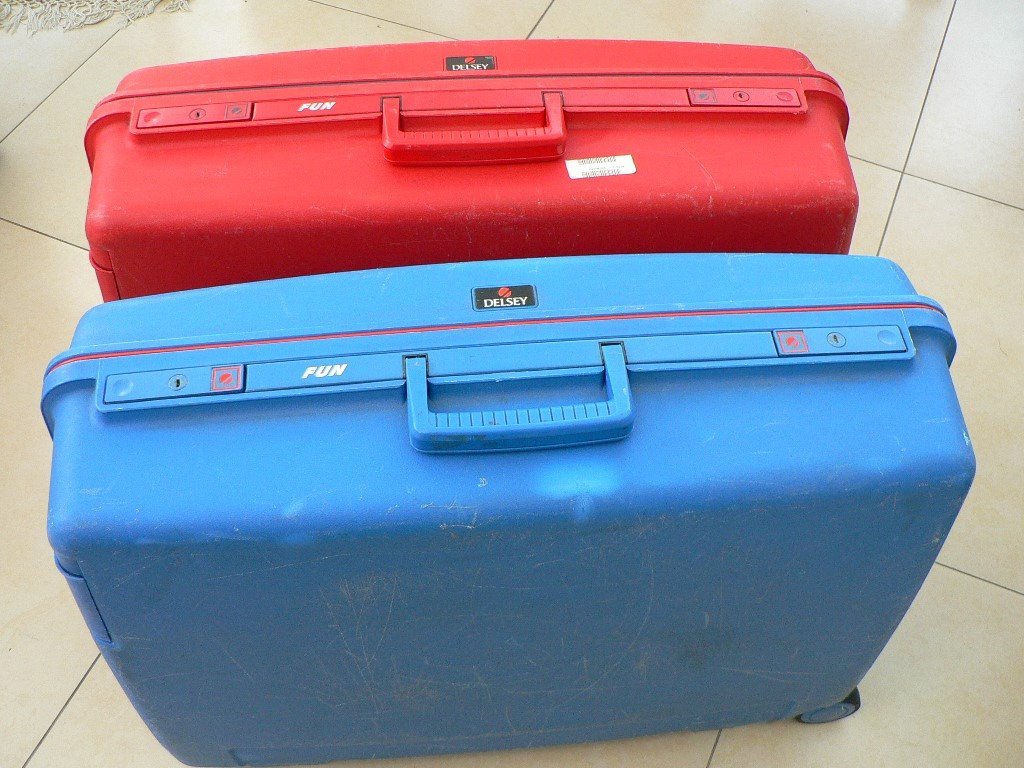 TWO QUALITY "DELSEY" HARD SHELL WHEELED AND LOCKABLE SUITCASES in