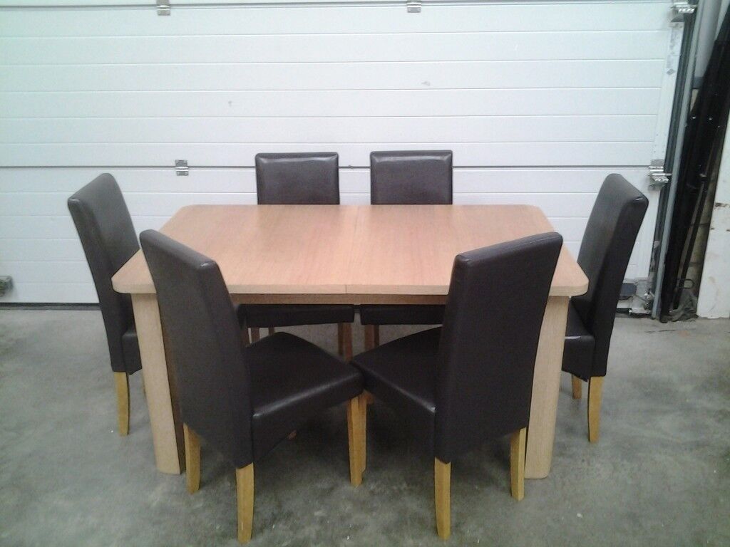 Ex display Extendable dining table and 6 choc brown faux 