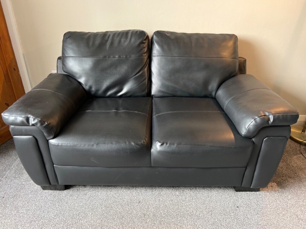 Free 2 seater black faux leather sofa in Huddersfield, West Yorkshire