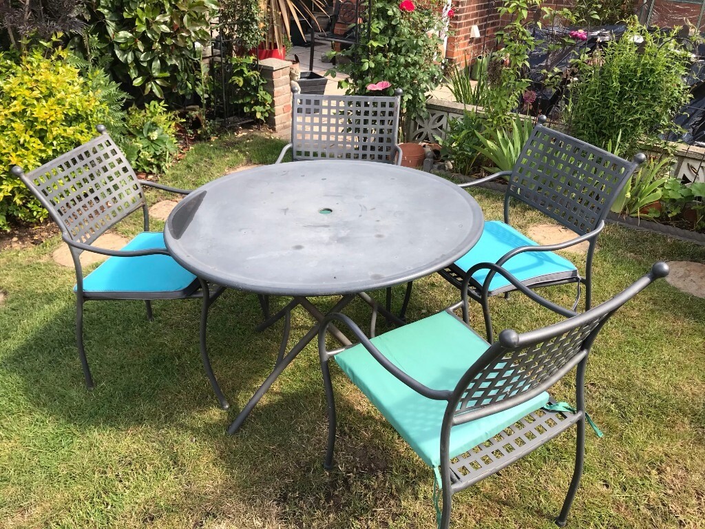 Steel garden table and 4 chairs. Used but in good condition. Complete
