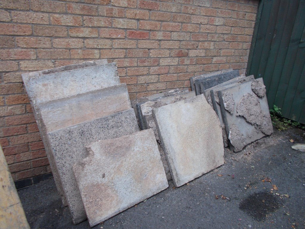 Heavy duty paving slabs, various sizes, some with cut outs from a fence