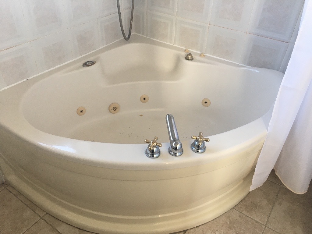 Full bathroom suite jacuzzi corner bath, w/c and basin in Pencoed
