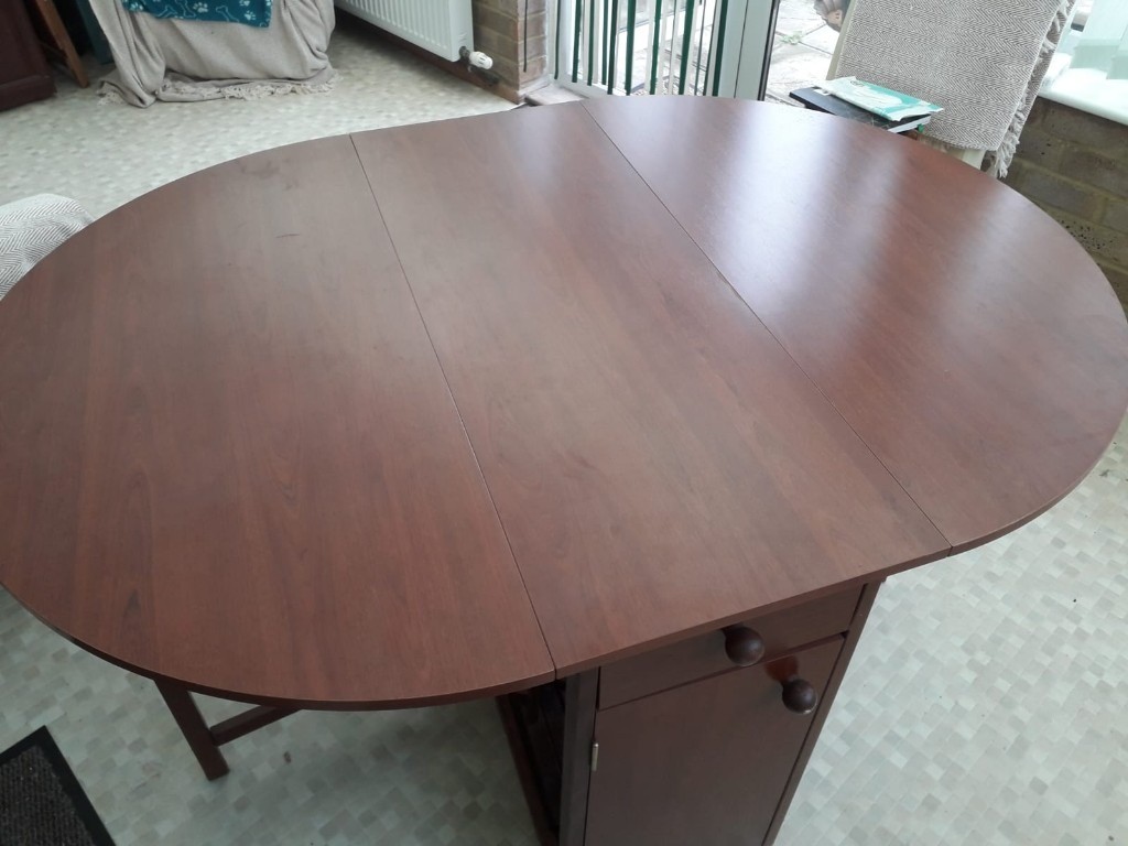 Dining room table with four fold down chairs that are ...