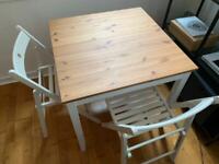 Table and two folding chairs 