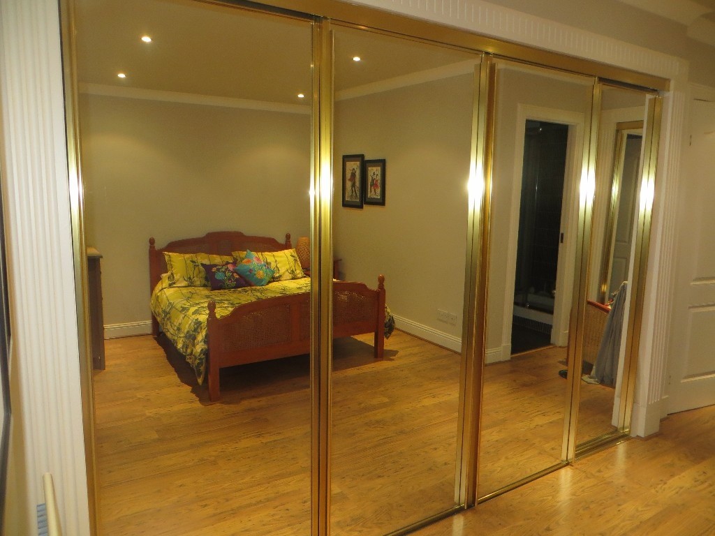 9 top quality sliding Wardrobe Doors.Gold coloured metal with matching
