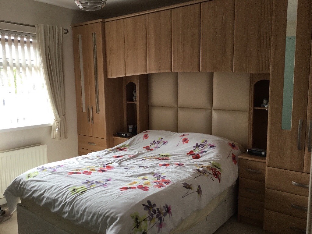 Fitted over bed wardrobe unit including leather headboard in Comber